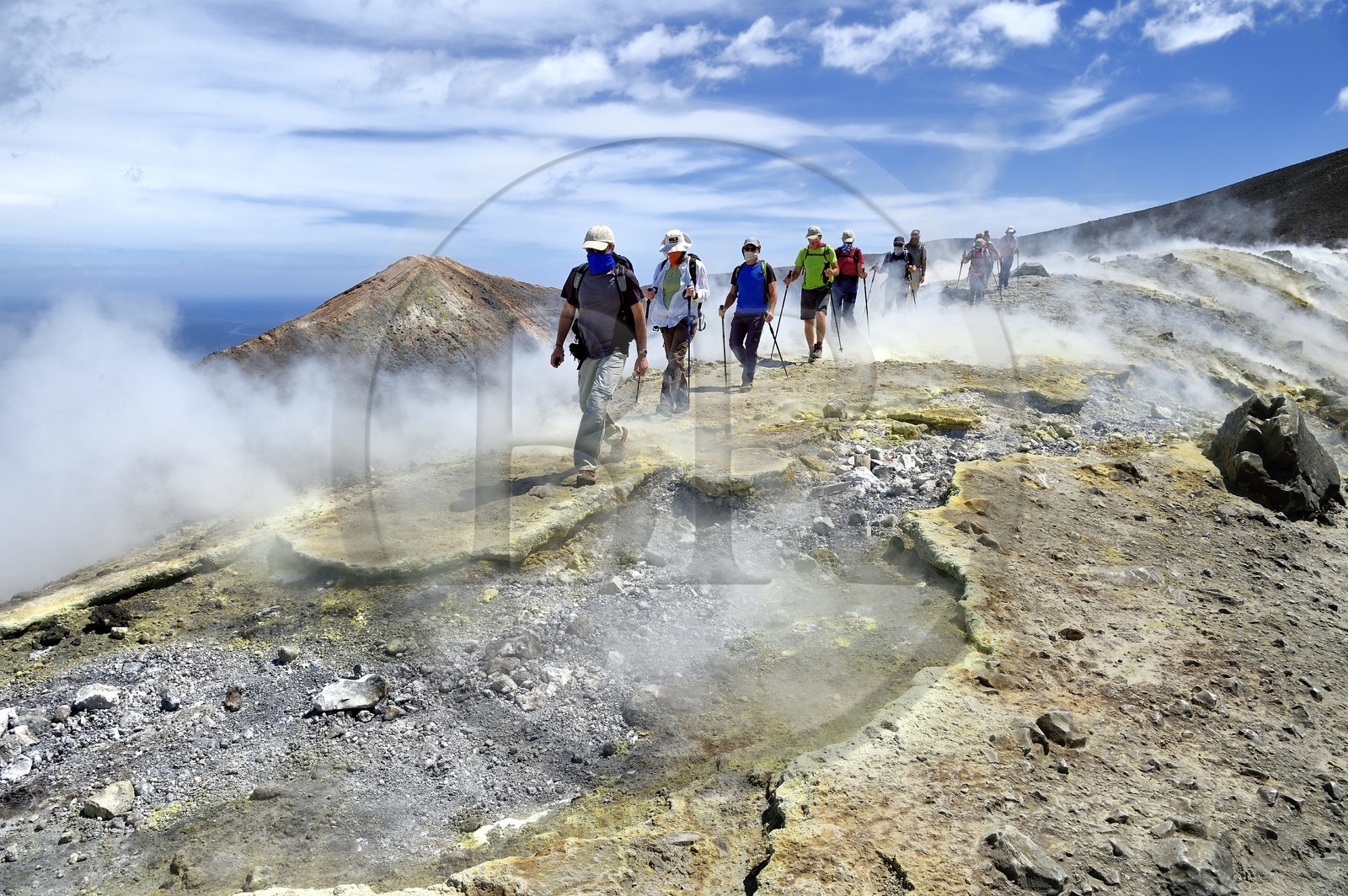 Italy, Sicily, Aeolian Islands, listed as World Heritage by UNESCO, Vulcano Island, hikers climbing the crater of volcano della Fossa through sulfur fumaroles