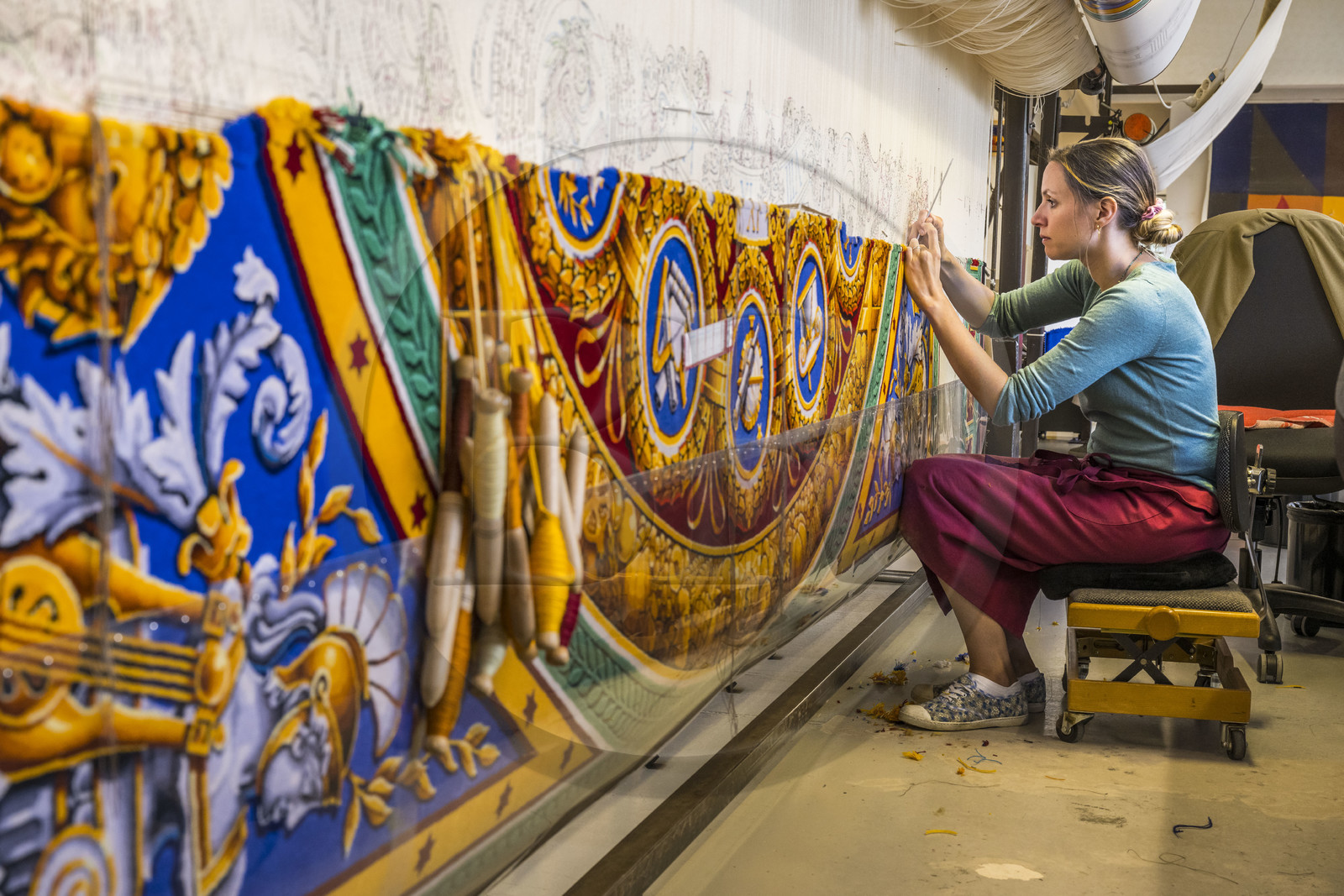 France, Herault, Lodève, Manufacture de la Savonnerie (Savonnerie manufactory) unique annex of the National Carpet Factory of the Savonnerie des Gobelins in Paris, manufacture of the Cohortes carpet after a model by Jacques-Louis de la Hamayde de Saint-Ange intended for the Palace of the Legion of Honor, the weaver Morgane Pognard unravels the colors on the loom