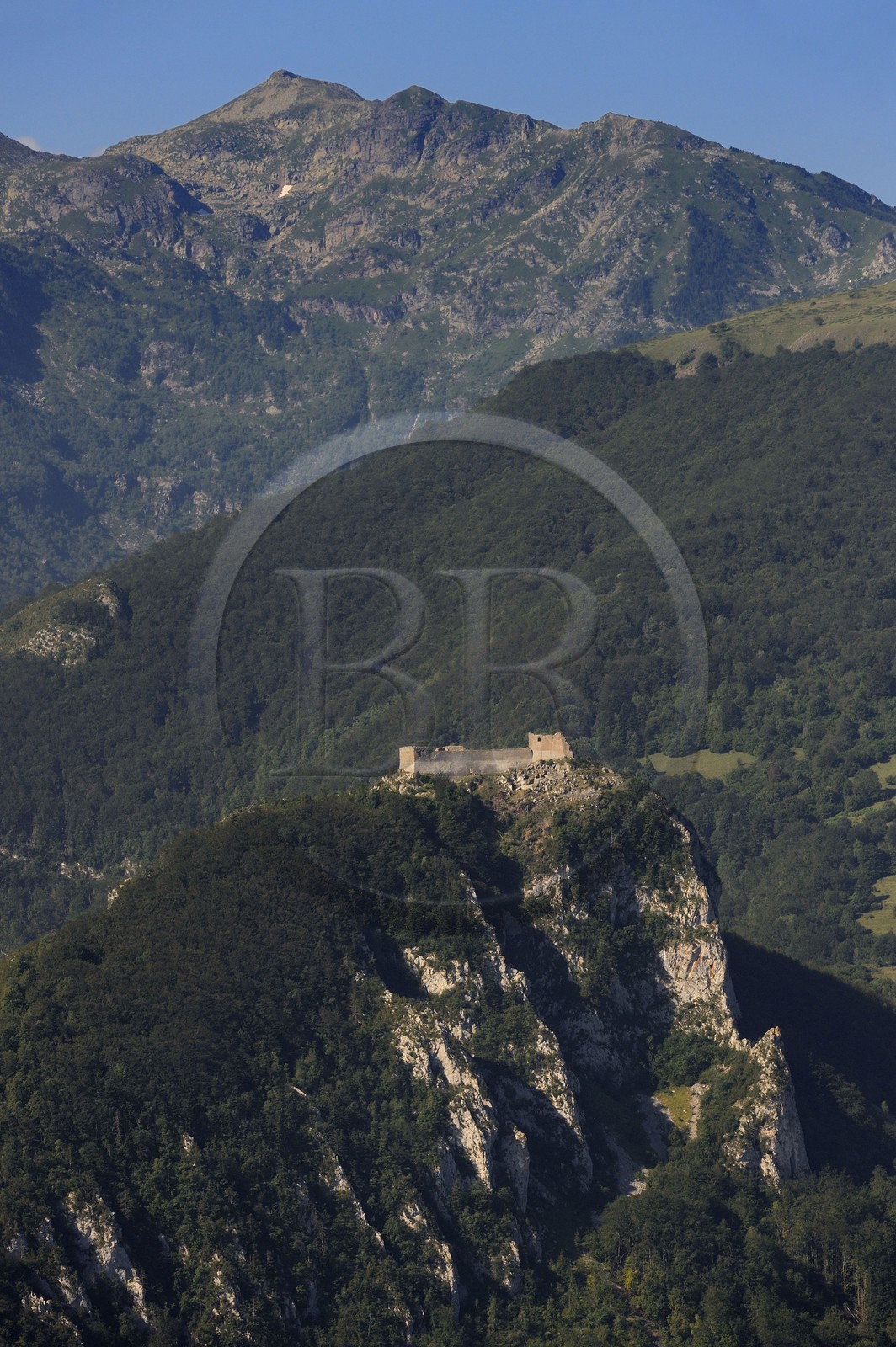 France, Ariege, Pays d' Olmes, Cathar Castle of Montsegur perched on a rock and the Pyrenees (aerial view)..