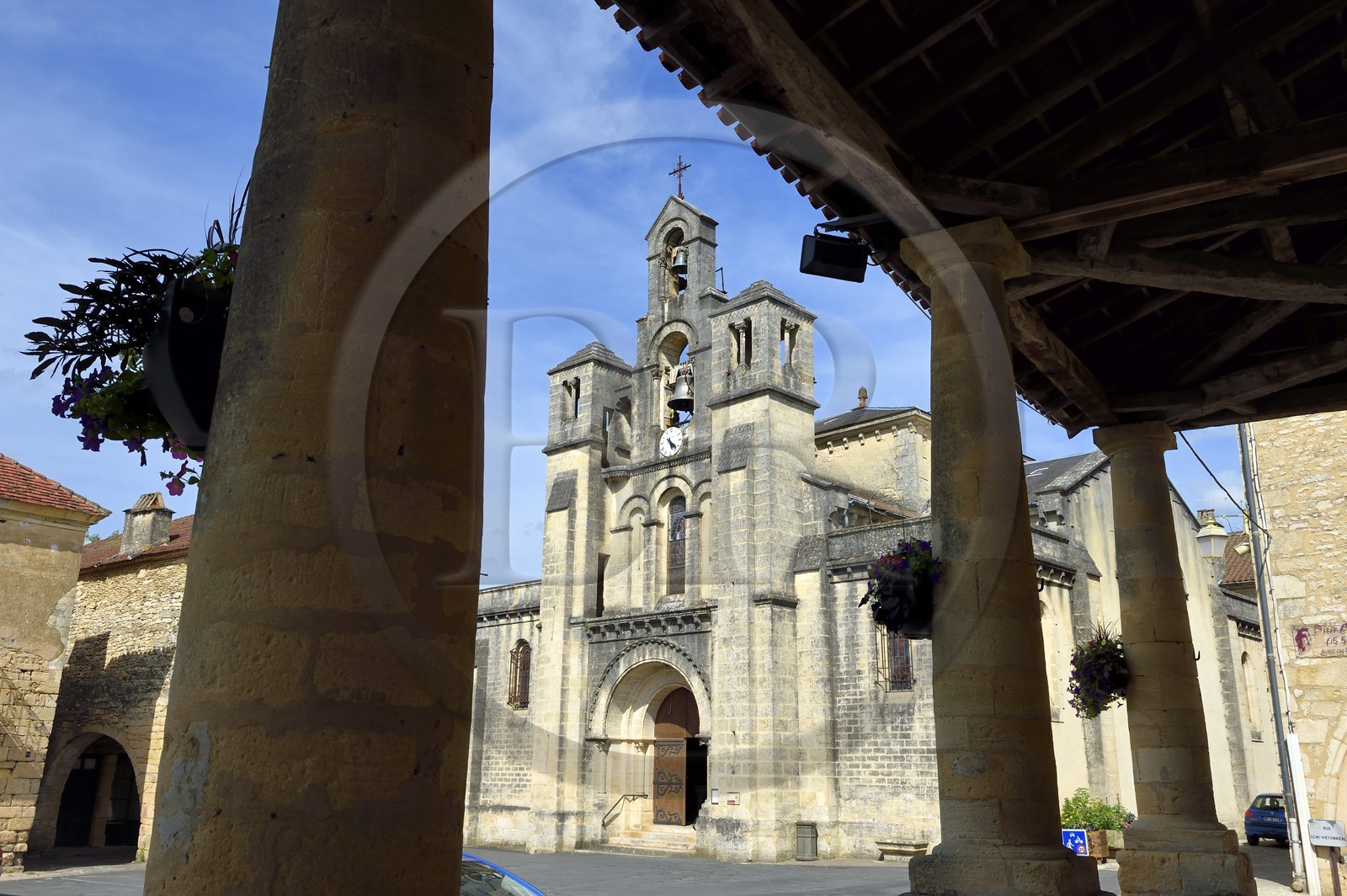 France, Dordogne, Perigord Noir, Villefranche du Perigord, the covered market and its Tuscan columns, in the background the church of Our Lady of the Assumption