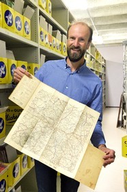 France, Puy de Dome, Clermont Ferrand, L'Aventure Michelin archives, museum retracing all the activities of the Michelin group, Stéphane Nicolas, responsible for historical heritage at Michelin, presents the very first 1908 test map of the Clermont-Ferrand region