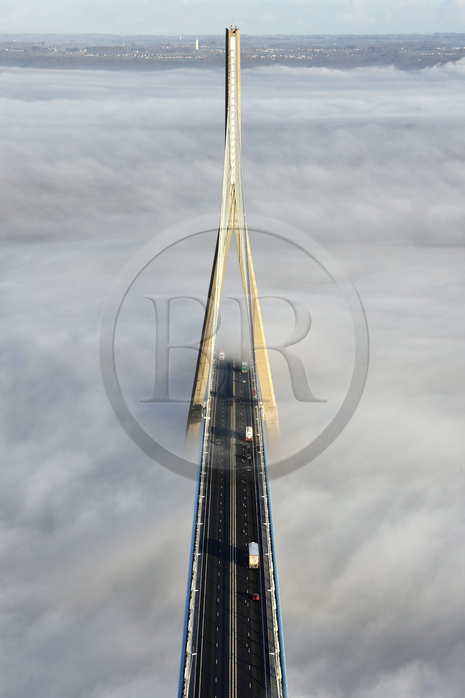 France, between  Calvados and Seine Maritime, the Pont de Normandie (Normandy Bridge) that emerges from the morning mist of autumn and spans the Seine, view from the top of the south pylon