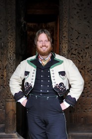 Norvège, Oslo, presqu'île de Bygdoy, musée du Folklore norvégien (Norsk Folkemuseum), homme en costume traditionel du dimanche d'un fermier du Telemark du 19ème siècle devant l'église en bois debout de Gol