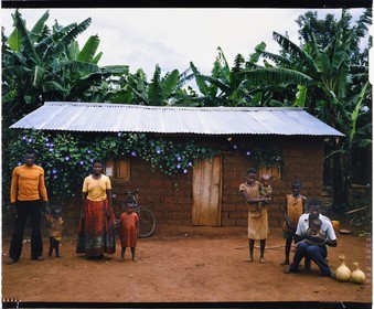 Burundi, Kirundo Province, Lake Cohoha region, Hutu peasant family posing in front of a modern hut, traditional habitat disappears in favor of square clay huts, whether or not coated with corrugated iron (4x5 reversal film reproduction)