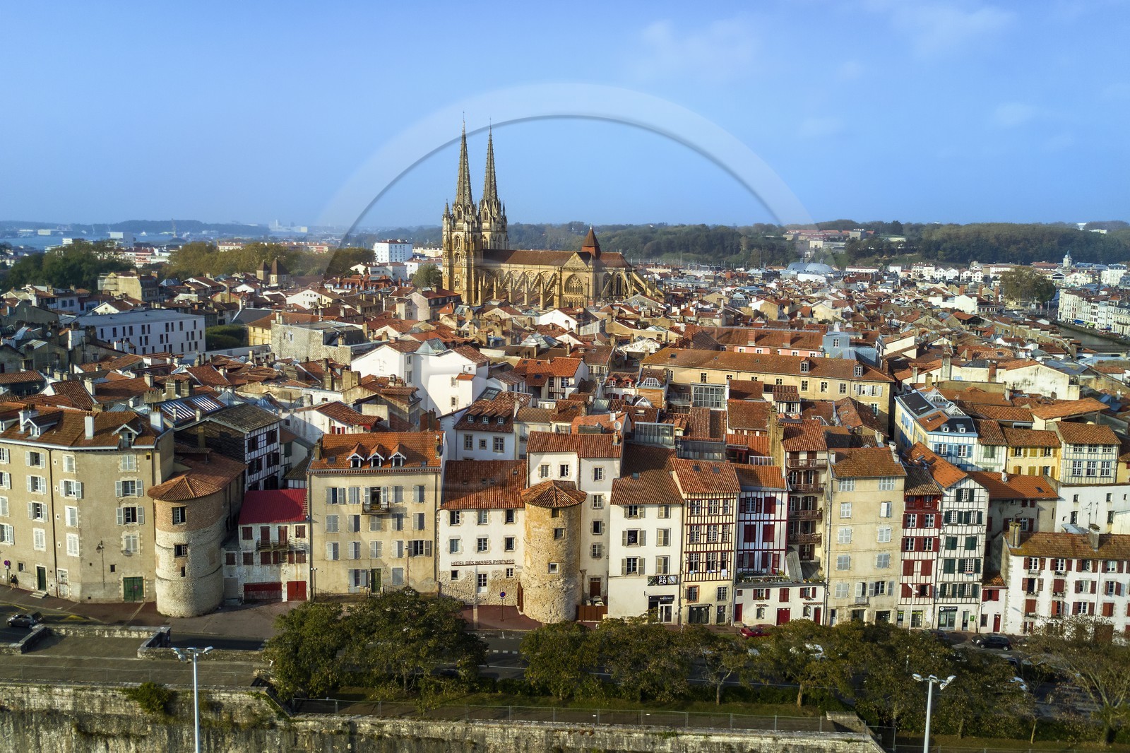 France, Pyrenees Atlantiques, Basque Country, Bayonne, the spires of St. Catherine's Cathedral behind the towers of the former ramparts integrated in the buildings of the rue Tour de Sault (aerial view)