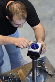 France, Moselle, Meisenthal, Centre international d'Art verrier (CIAV) (international glass centre), the blowing workshop, crafting a Christmas ball, finalization of the installation of the glass hook