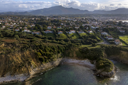 France, Pyrenees Atlantiques, Basque Country coast, Saint-Jean-de-Luz, the coastal path on the GR 8 running along the flysch cliff of the Pile d'Assiettes, a sort of mille-feuille alternating hard rocks and soft rocks, the mountain of La Rhune in the background (aerial view)