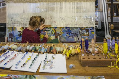 France, Herault, Lodève, Manufacture de la Savonnerie (Savonnerie manufactory) unique annex of the National Carpet Factory of the Savonnerie des Gobelins in Paris, realization by the weaver Kristell Corbinais on a loom of a seat tapestry for the bench L'Iris dans la vallée designed by Philippe Borderieux, mowing action