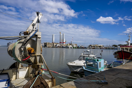 France, Loire-Atlantique, Saint-Nazaire, fishing boats in the harbour basin and the fortified lock of the former German submarine base built during the last world war in the background