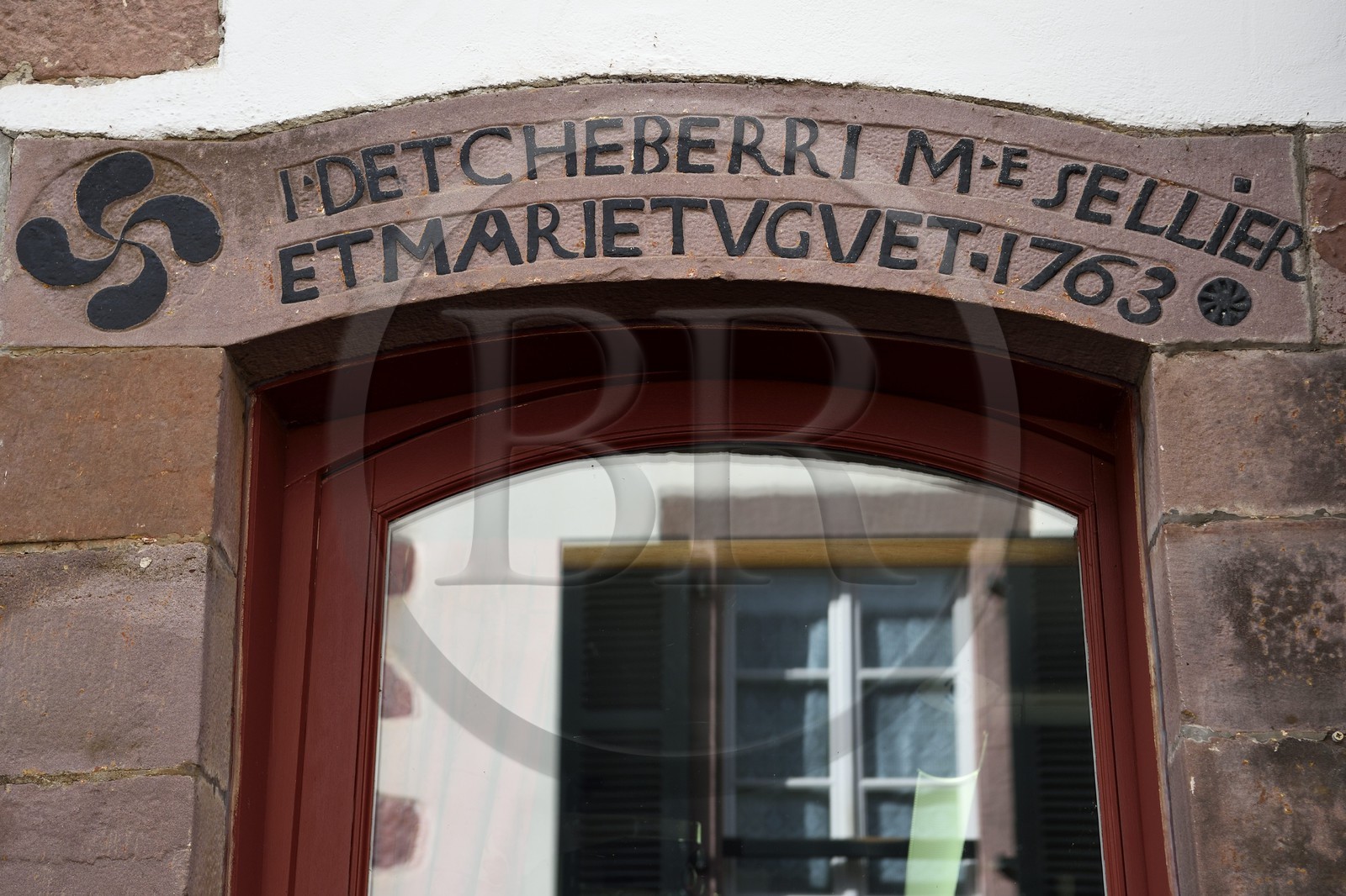France, Pyrénées-Atlantiques (64), Pays-Basque, Saint-Jean-Pied-de-Port, rue d'Espagne sur le chemin de Saint-Jacques-de-Compostelle, linteau de la maison de monsieur Detcheberri qui était maitre sellier en 1763, à gauche lauburu ou croix basque