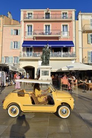 France, Var, Saint-Tropez, Fiat 500 advertising convertible passing in front of the statue of vice-admiral Suffren and the Sube hotel on Suffren wharf on the port