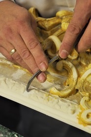 France, Yvelines, Chateau de Versailles, the castle restoration workshop, gilt workshop, Laurent Hissier working on a frame
