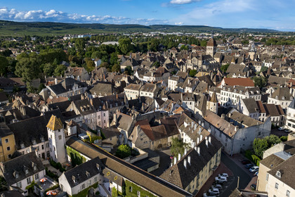 France, Cote d'Or, Climats terroirs of Burgundy listed as World Heritage by UNESCO, Beaune, private mansions in the old town, the Notre-Dame de Beaune collegiate basilica on the right and the Côte de Beaune on the left in the background (aerial view)