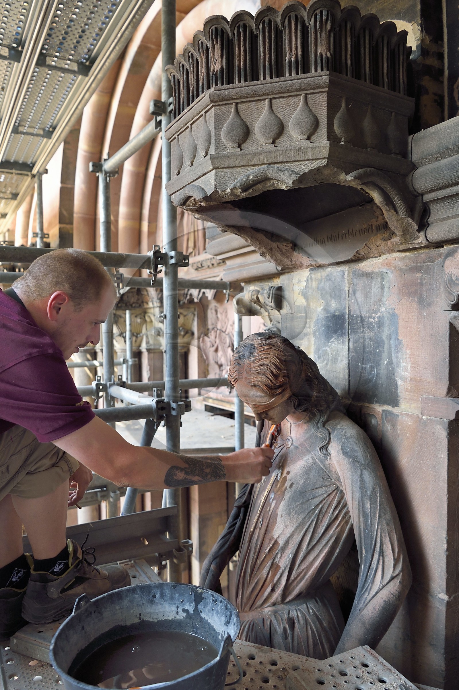 France, Bas Rhin, Strasbourg, old town listed as World Heritage by UNESCO, Notre Dame Cathedral, Judgment Day Portal Restoration Site, cleaning of the so-called Synagogue sculpture with a toothbrush by a stonemason companion