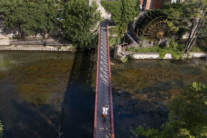 France, Vaucluse, Le Thor, bridge over the Sorgue river and an old water mill paddle wheel (aerial view)