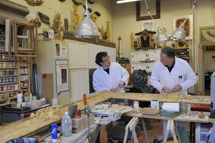 France, Yvelines, Chateau de Versailles, the castle restoration workshop, gilt workshop, Laurent Hissier working on a frame
