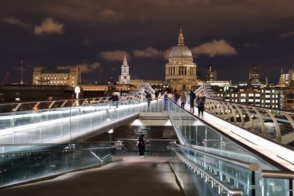 United Kingdom, London, the Millennium Bridge by architect Norman Foster on the Thames river and St. Paul's Cathedral in the background