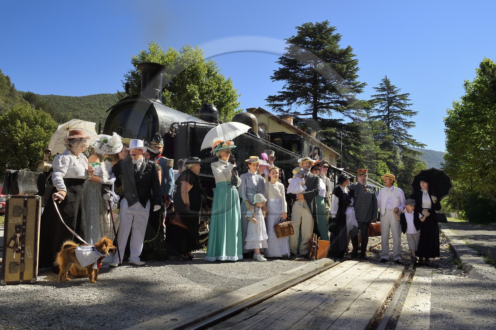 France, Alpes-Maritimes, Puget Theniers, the Train des Pignes historic train, members of the AHVAE (Association d'histoire vivante et de d'archeologie expérimentale) in Belle Epoque costume in front of the steam engine