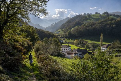 France, Pyrenees Atlantiques, Basque Country, Aldudes valley, hiker on a trail leading to the village of Urepel
