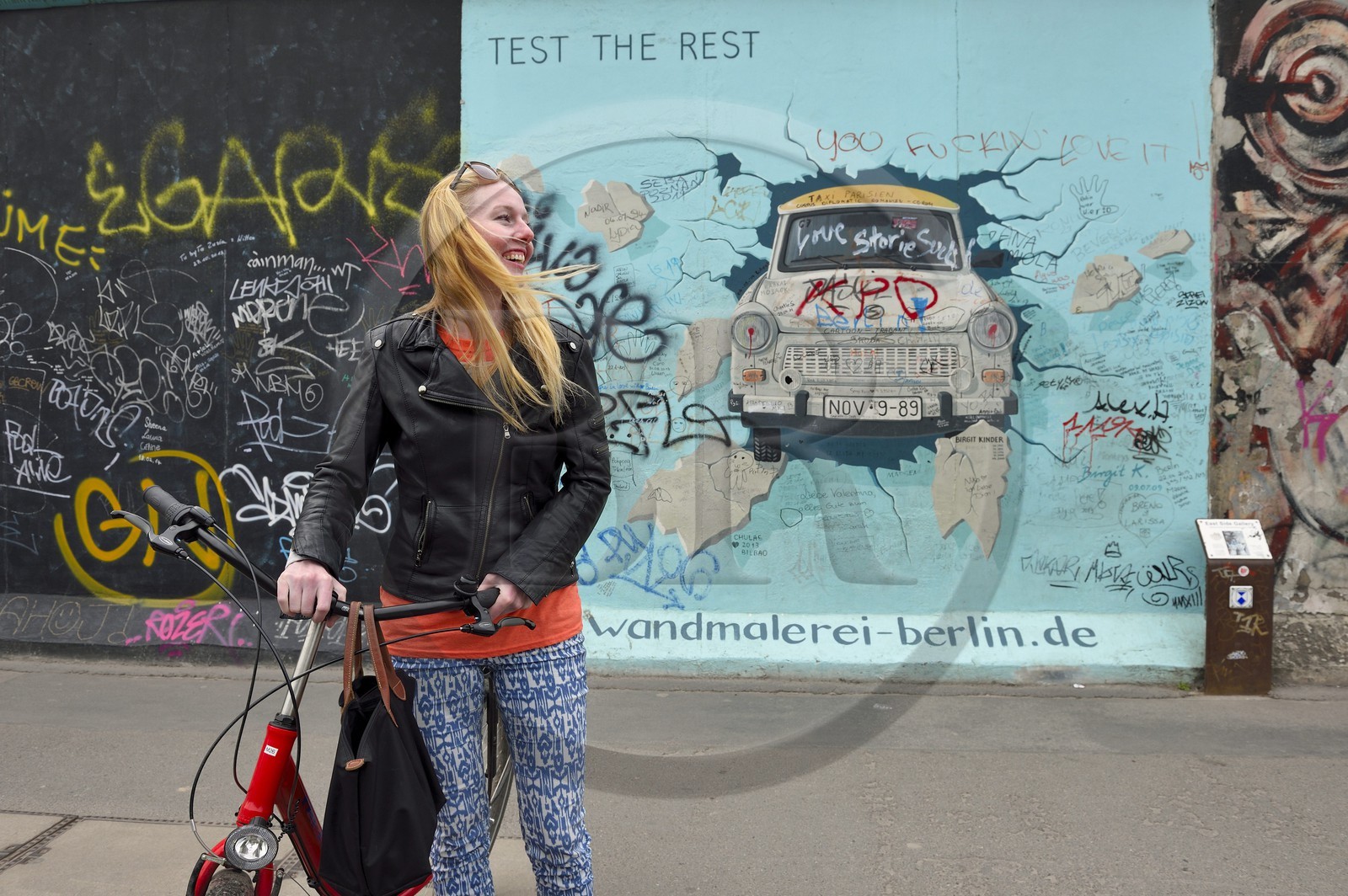 Germany, Berlin, Friedrichshain-Kreuzberg, East Side Gallery, The Wall, work by Birgit Kinder dating from the 1990's, renovated in 2009, representing a Trabant arriving in East Berlin, entitled Test the Best