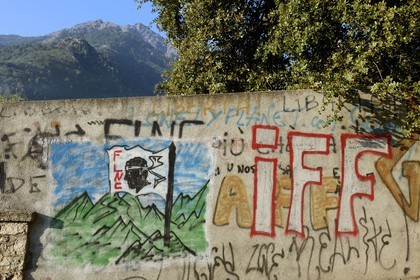 France, Haute Corse, Corte, separatist and political graffiti with the Moor's head emblem of Corsica