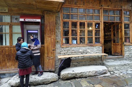 Azerbaijan, Ismailli region, Lahij (Lahic) main road, women using a cashpoint or ATM
