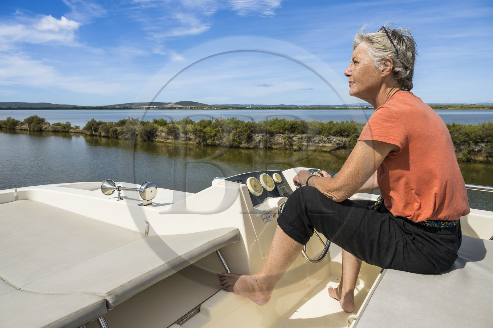 France, Herault, Villeneuve les Maguelone, navigation of a pleasure boat Le Boat on the Rhone to Sète Canal on the edge of the Arnel pond in the background