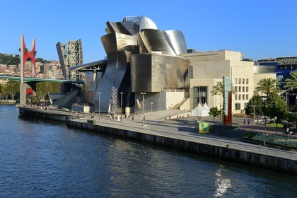 Spain, Basque Country Region, Vizcaya Province, Bilbao, the Guggenheim Museum designed by Frank Gehry and the Salve bridge with Les Arches Rouges artpiece by French artist Daniel Buren in the background