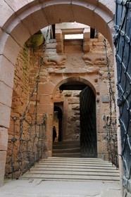 France, Bas Rhin, Orschwiller, Alsace Wine Road, Haut Koenigsbourg Castle, romanic lintel with two lying lions flanking arms of the late Middle Ages on the top of the stairs leading to the lodging house
