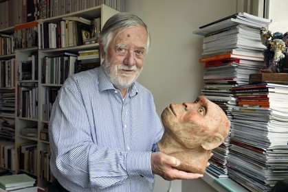France, Paris, the french paleontologist and paleoanthropologist Yves Coppens, professor at the College de France, in the office of his home in Paris, he holds in his hand the supposed reproduction of Lucy's face
