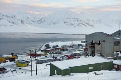 Norway, Svalbard, Spitzbergen, Longyearbyen, the industrial zone of the city and in the foreground the abandoned central cableway building used for transporting coal in carts from the mines to the harbour