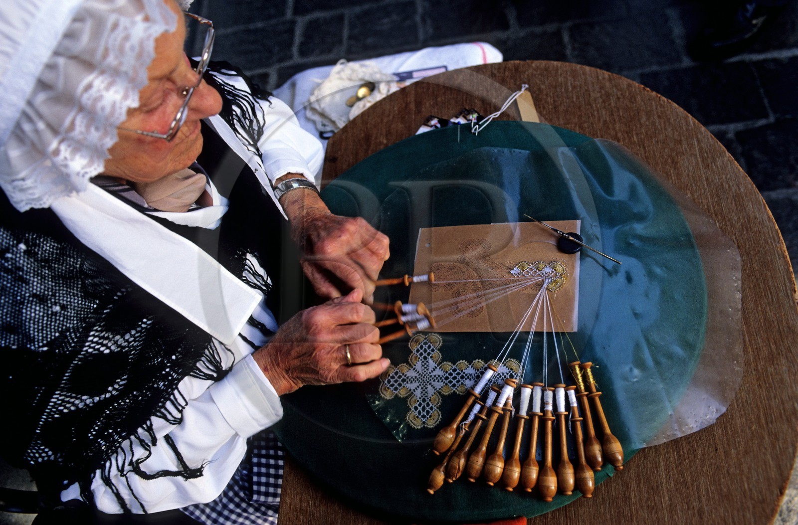 Belgium, West Flanders, Bruges (Brugge), one of the last lacemakers of the city on her work