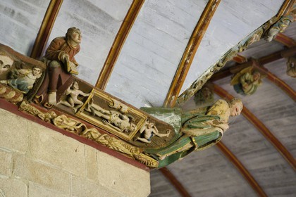 France, Finistere, Pleyben church, wooden painted sculptures on the stringer decorating the vault