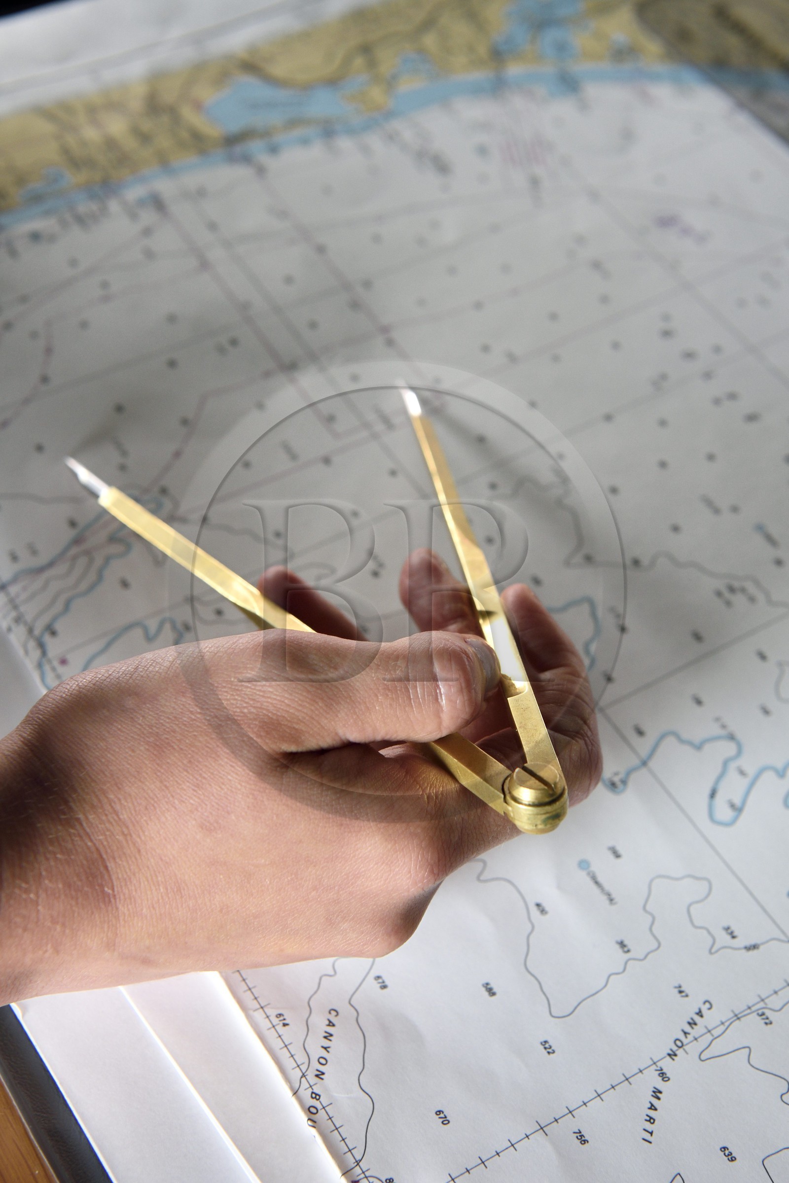 France, Var, Toulon, the naval base (Arsenal), the Charles de Gaulle nuclear-powered aircraft carrier on mid-life renovation, navigation bridge officer studying a map with her compass