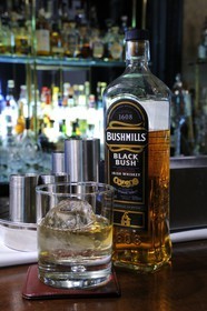 United Kingdom, Northern Ireland, Belfast, The Merchant Hotel bar in a former bank, bottle of Bushmills whiskey