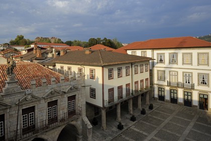 Portugal, Minho region, Guimaraes, town listed as World Heritage by UNESCO, former City Hall in the foreground on Largo da Oliveira square