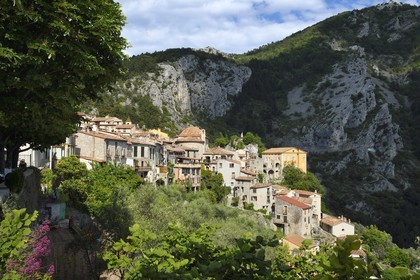 France, Alpes-Maritimes, the hilltop village of Peille, the Chapel of St. Sebastian (town hall), the War Memorial and the Palais Lascaris, right on the edge of the cliff