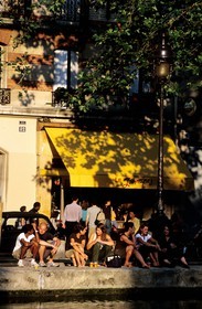France, Paris (75), jeunes gens sur le quai de Jemmapes au bord du canal Saint-Martin en été