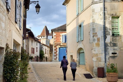 France, Dordogne, Périgord Vert, Saint Jean de Cole labelled Les Plus Beaux Villages de France (The Most Beautiful Villages of France), an alley in the village and the Chateau de la Marthonye or Marthonie in the background