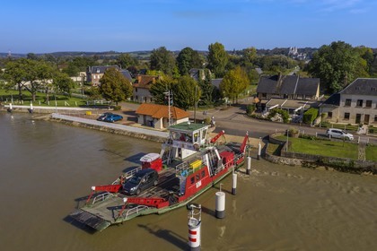 France, Seine-Maritime, Pays de Caux, Norman Seine River Meanders Regional Nature Park, the ferry crossing the Seine at Jumieges which abbey is in the background