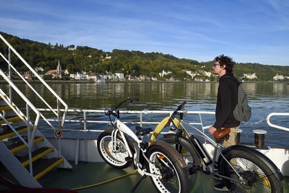 France, Seine-Maritime, Norman Seine River Meanders Regional Nature Park, the ferry crossing the Seine at the village of La Bouille, cyclists on the Veloroute of Val de Seine