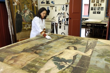 Brazil, Minas Gerais state, Ouro Preto, historical center listed as World Heritage by UNESCO, Maria Alice restoring a painting from a church in town for FAOP (Fundacao de Arte de Ouro Preto) (Gold Route, Estrada Real)
