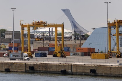 Canada, Quebec Province, commercial port on the Saint Lawrence River and the tower of the Olympic Stadium