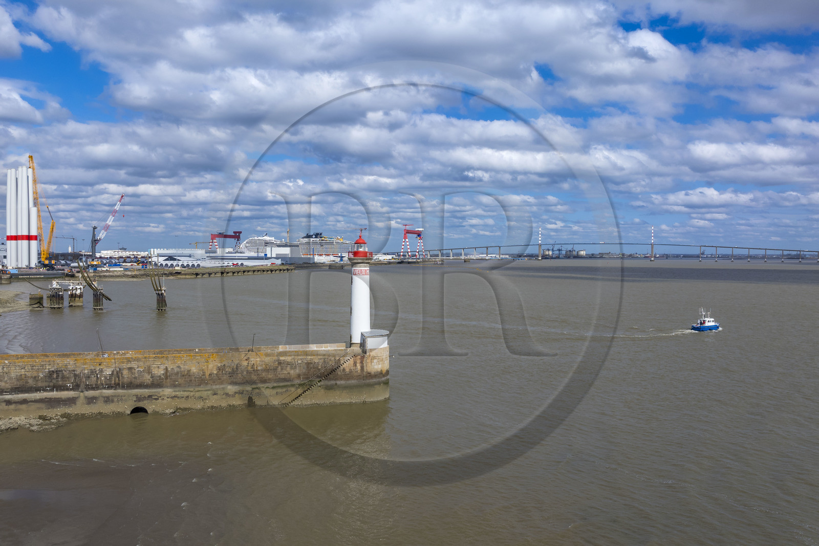 France, Loire-Atlantique, Saint-Nazaire, the Vieux Mole lighthouse, the 333m MSC World America cruise ship built by Chantiers de l'Atlantique and the Saint Nazaire bridge in the background (aerial view)