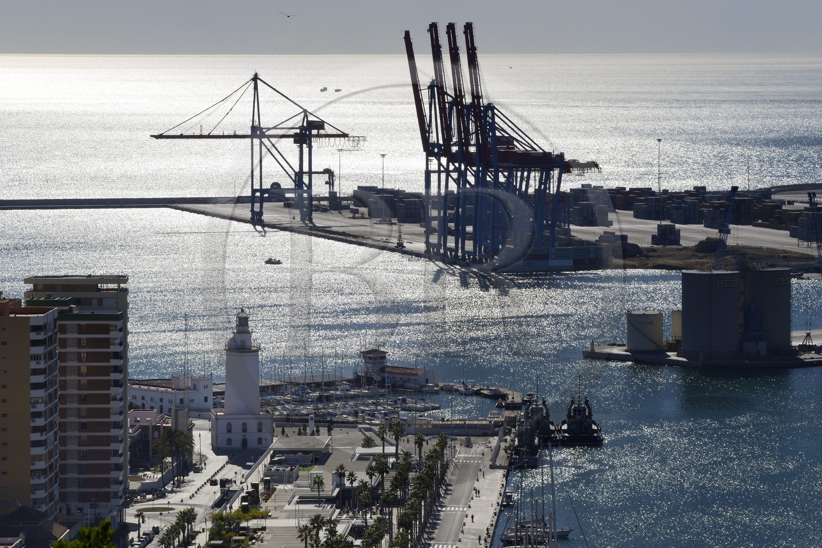 Spain, Andalusia, Malaga, the harbour cranes and the lighthouse