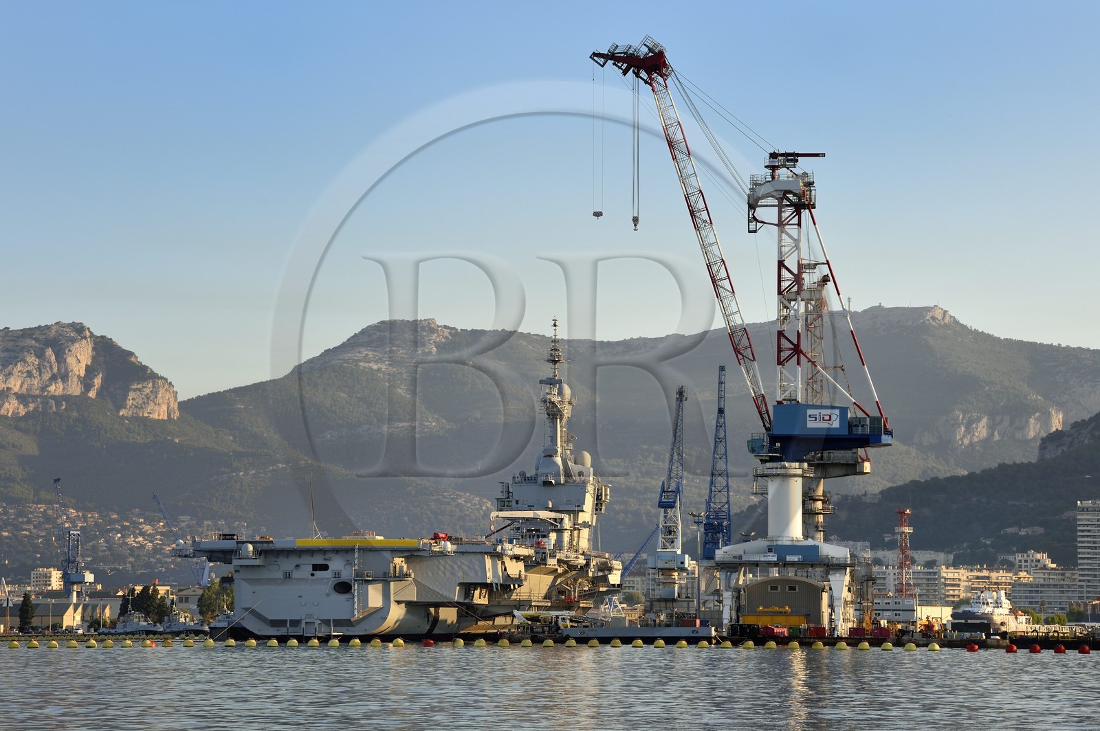 France, Var, Toulon, the naval base (Arsenal), the Charles de Gaulle nuclear-powered aircraft carrier on mid-life renovation and the mont Caume in the background