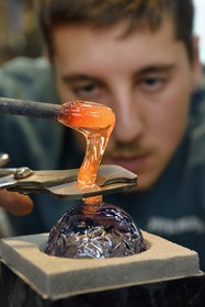 France, Moselle, Meisenthal, Centre international d'Art verrier (CIAV) (international glass centre), the blowing workshop, crafting a Christmas ball, installation of the pellet for the creation of the glass hook