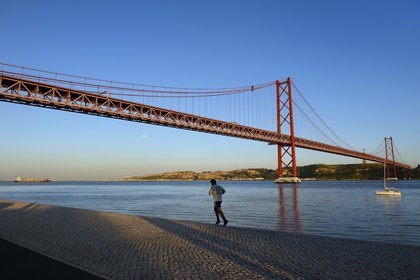 Portugal, Lisbon, 25 de Abril bridge on Tagus river and the Cristo Rei (Christ the King)