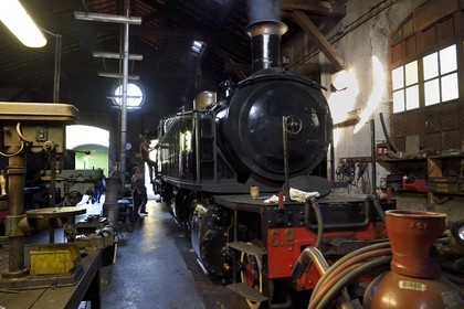 France, Alpes-Maritimes, Puget Theniers, the Train des Pignes, steam engine warming up in the maintenance workshop at the motive power depot