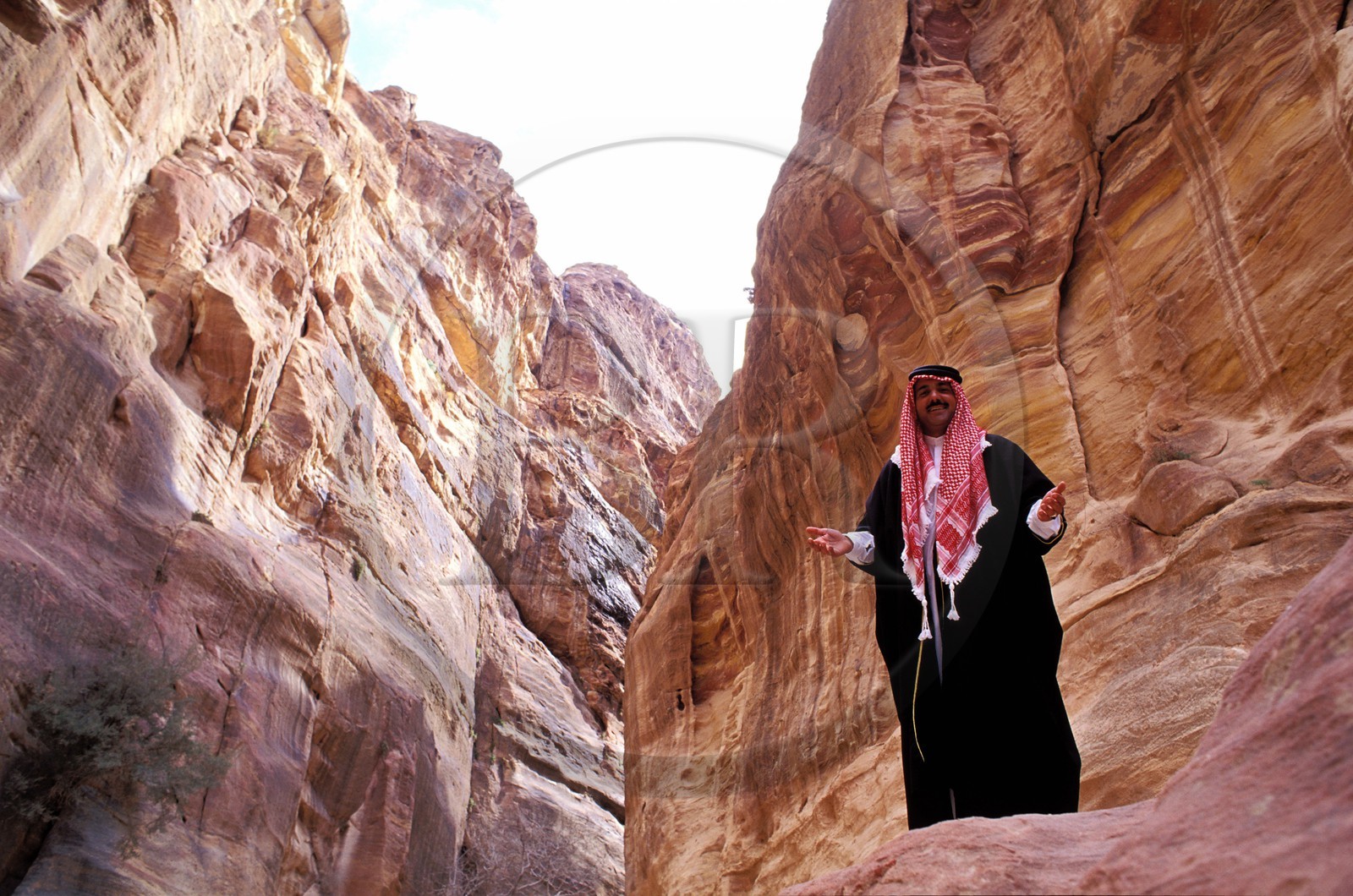 Jordan, Petra, Bedouin contemplating the sîq dug by Wadi Mousa river and leading to the Khazneh